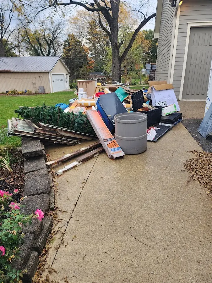 Dumpster being loaded with debris for Estate Cleanout Dumpster Rental in Gray